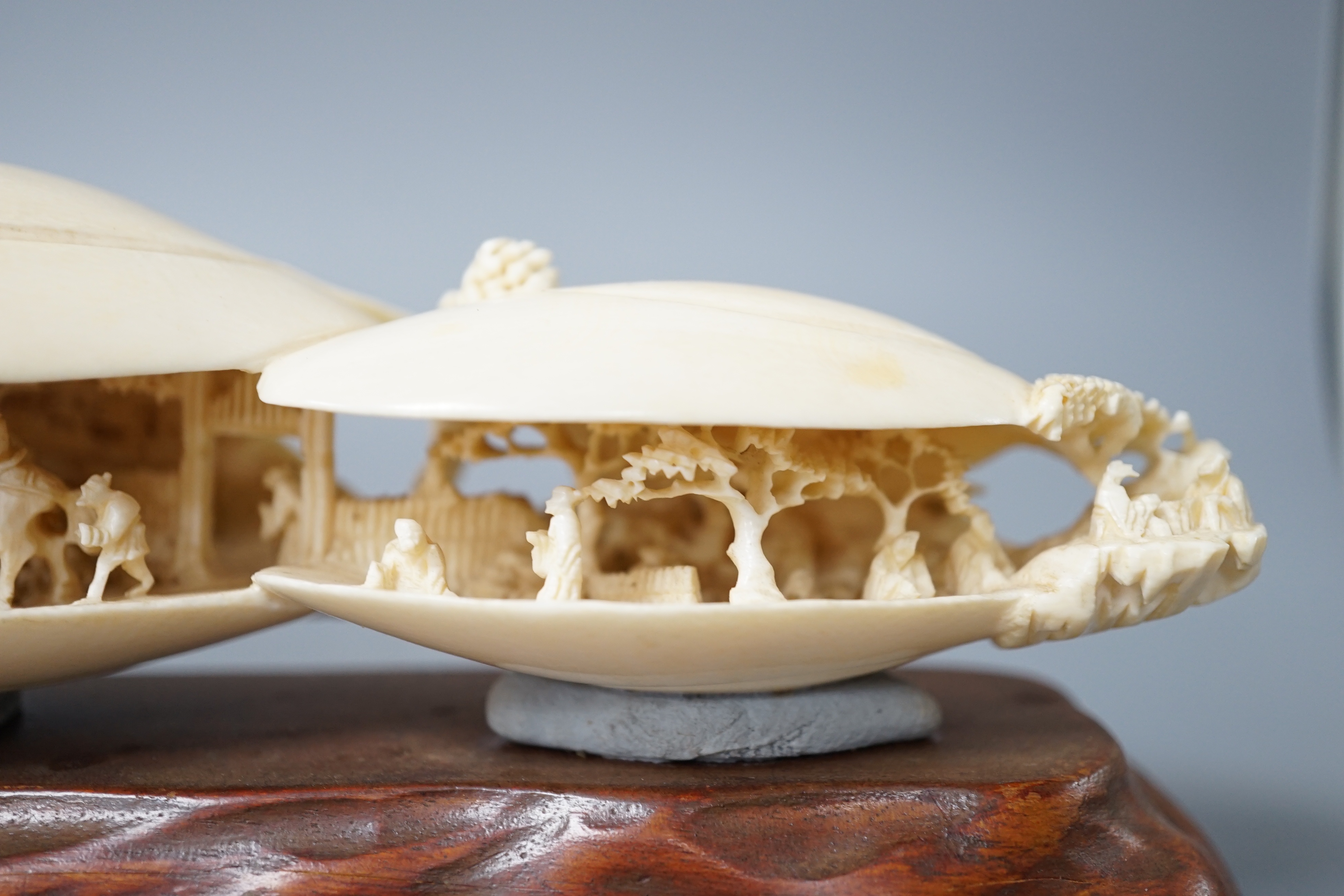 A large Japanese ivory model of the clam’s dream, Meiji period, wood stand. 18cm long